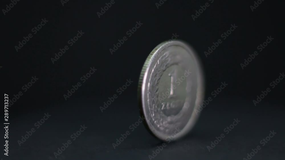 One Polish Zloty Coin Rotating On Black Background. One Polish Zloty Coin Rotating On Black Background.