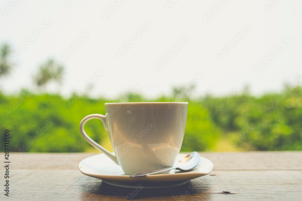 Hot coffee on blur fresh garden background Hot coffee on blur fresh garden background