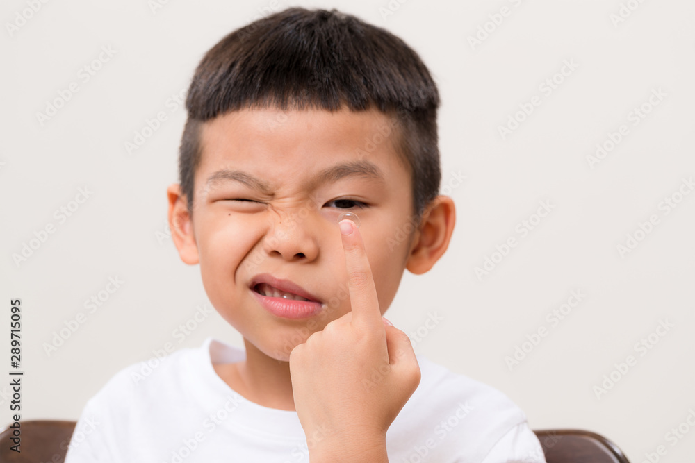 Asian boy look at contact lens Asian boy look at contact lens