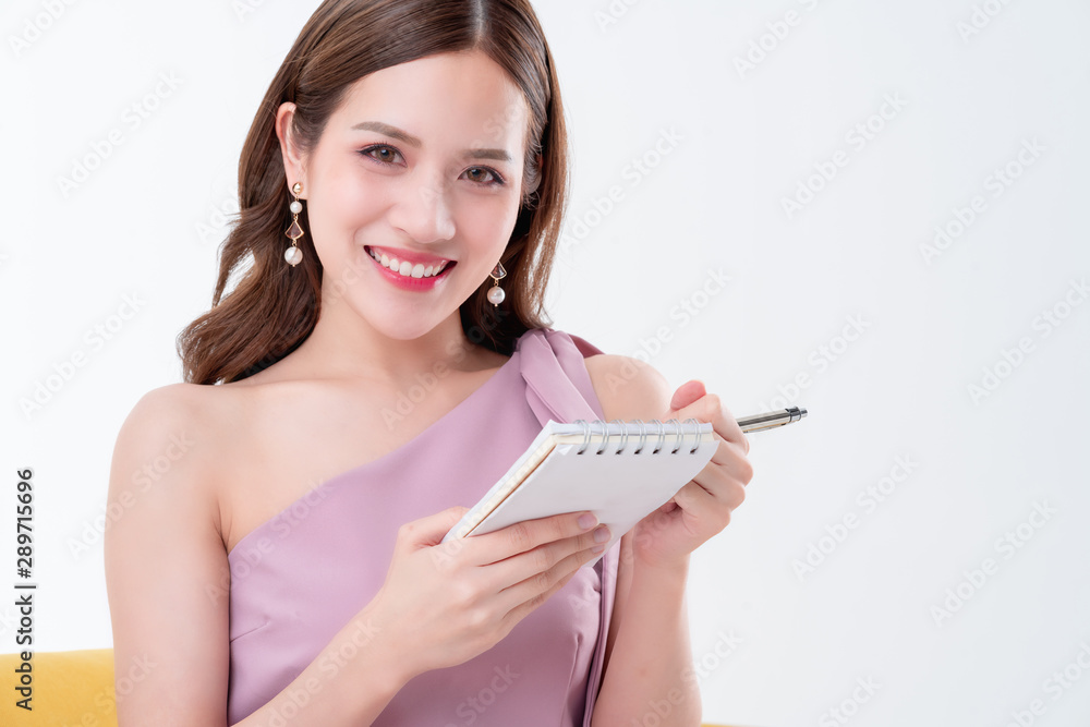 beautiful elegance asian woman pink dress hand hold paper note and pencil thinking ideas concept white background beautiful elegance asian woman pink dress hand hold paper note and pencil thinking ideas concept white background
