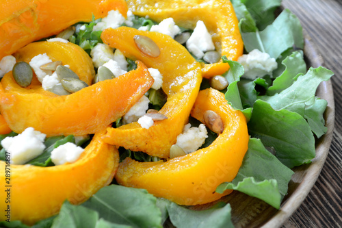Warm autumn pumpkin salad with seeds and soft cheese Healthy food concept