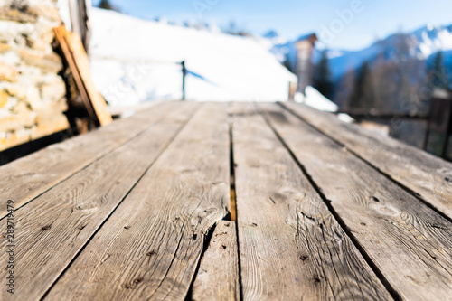 Wooden board empty table in front of blurred mountain background.