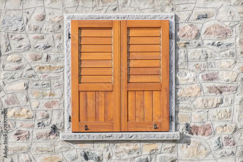 Modern close wooden window isolated on stone bricks wall,