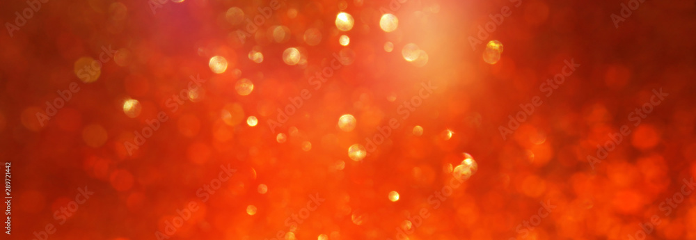 background of gold and orange glitter lights. de focused background of gold and orange glitter lights. de focused