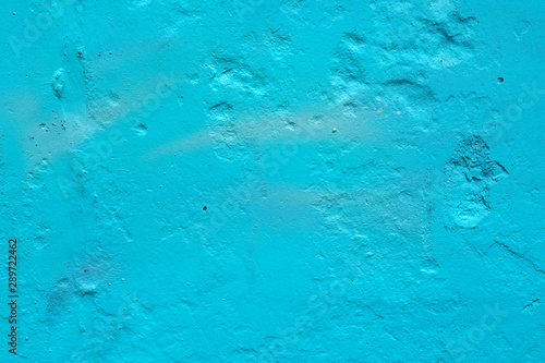 texture of a painted wall. cement plate blue color background. wall with bumps and small pits.