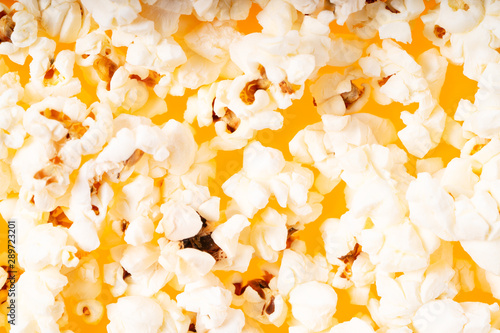 Scattered popcorn over yellow background