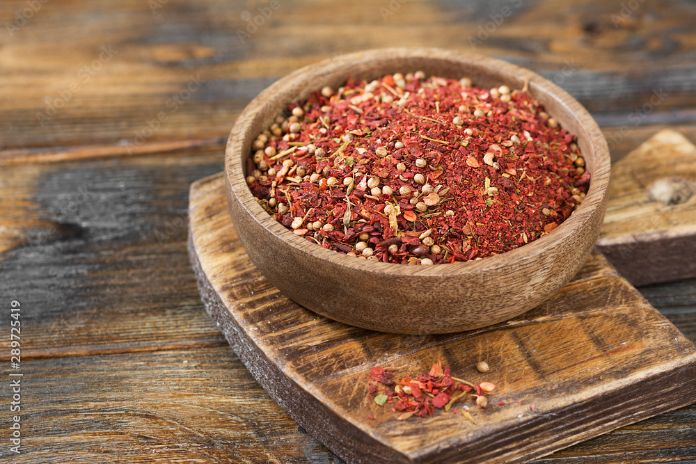 Set of spices in a wooden bowl on a wooden table Set of spices in a wooden bowl on a wooden table