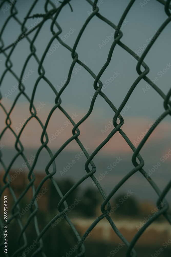 Fototapeta premium chain link fence with barbed wire