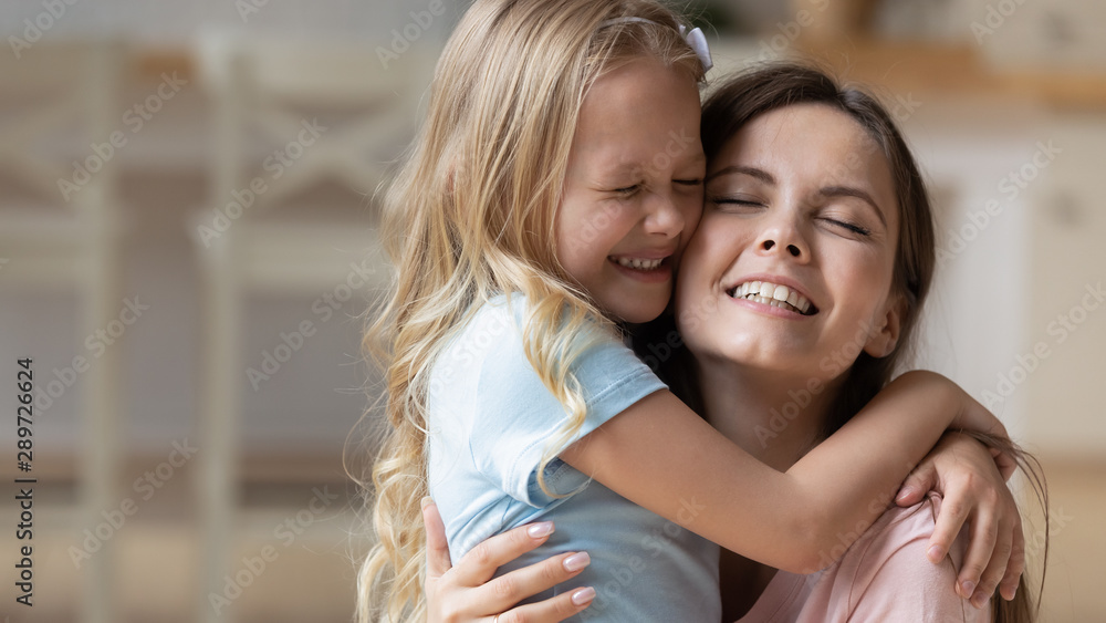 Adorable blonde adopted little girl cuddling mommy. Adorable blonde adopted little girl cuddling mommy.
