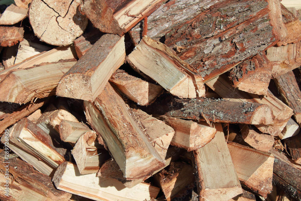 A pile of chopped firewood. Close-up. Background. Texture. A pile of chopped firewood. Close-up. Background. Texture.