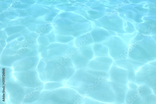 Clear bluish water in the sea. Top view. Close-up. Background. Texture.