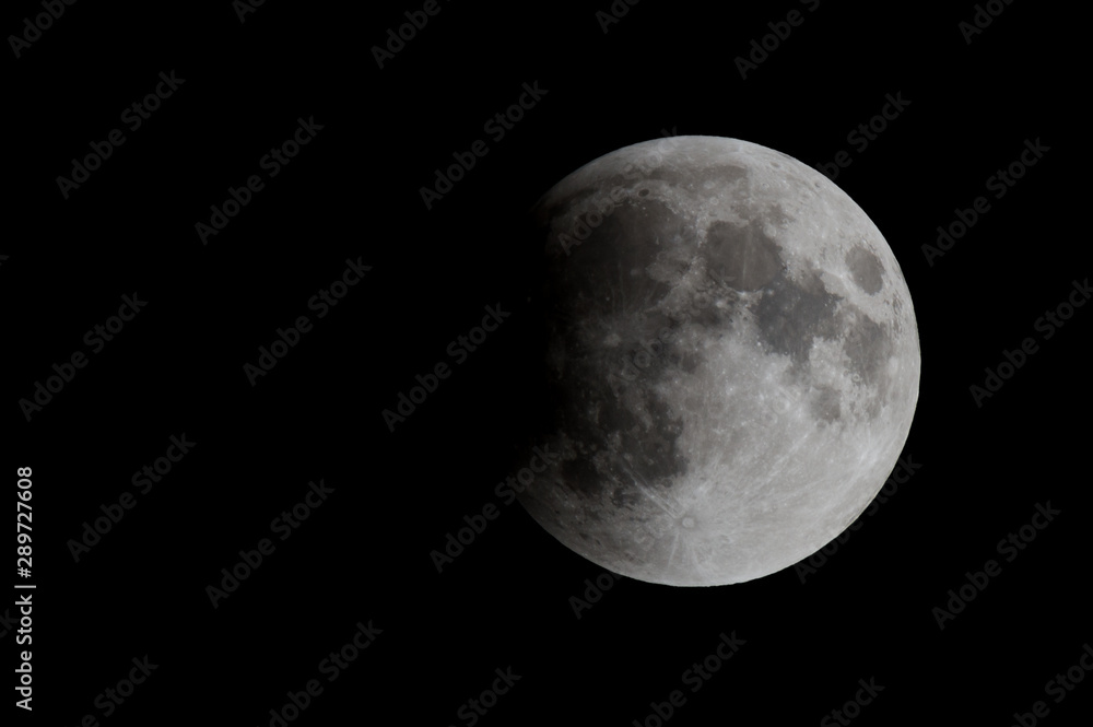The moon during a lunar eclipse. About one third of the moon is in the shadow of the earth. There is room for text. The moon during a lunar eclipse. About one third of the moon is in the shadow of the earth. There is room for text.