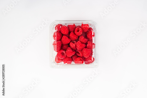 raspberries in a box isolated on white