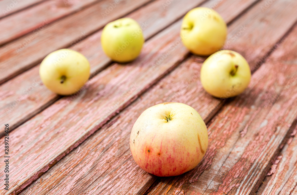 Apples on the weathered wooden table background