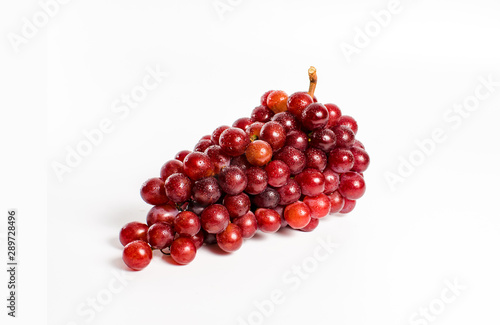 A bunch of red grapes on a white background
