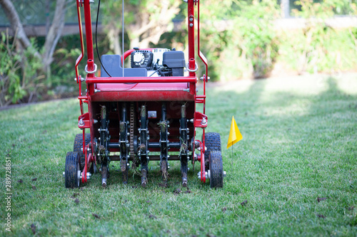 Red grass lawn aerator