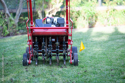 Red grass lawn aerator photo