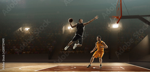 Two basketball players in action fighting for the ball near hoop © TandemBranding