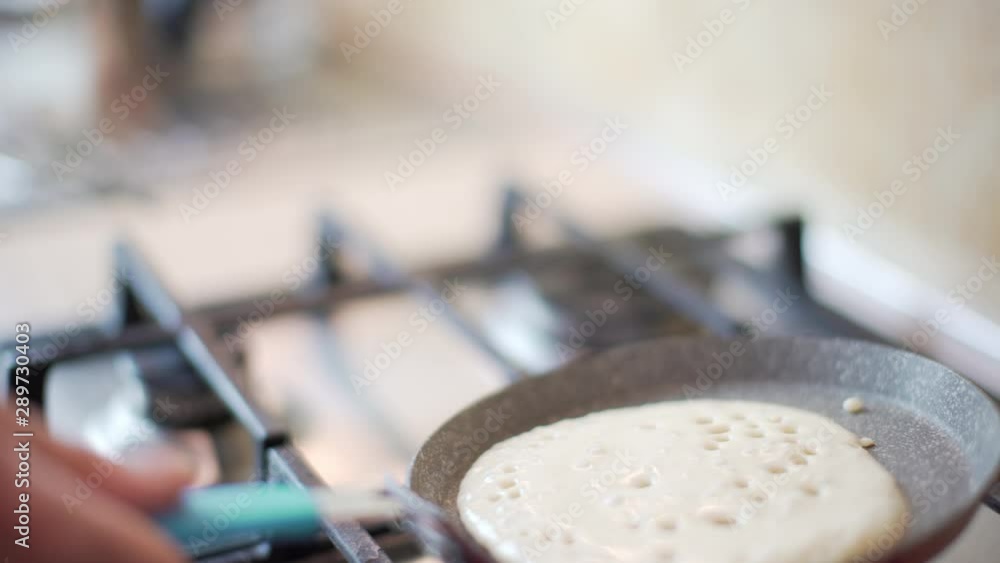 Preparing and cooking in the kitchen of a home tasty organic pancakes for breakfast in a pan and flip it. Food. Preparing and cooking in the kitchen of a home tasty organic pancakes for breakfast in a pan and flip it. Food.