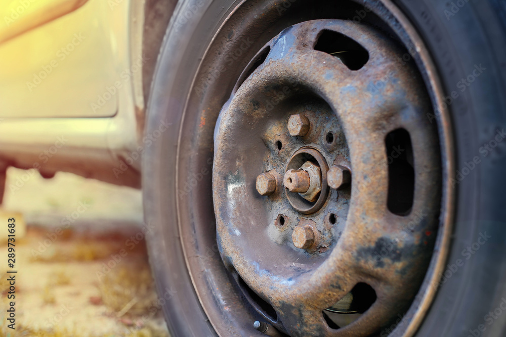 replacing a wheel in a car, loosening nuts with a hand wrench. replacing a wheel in a car, loosening nuts with a hand wrench.