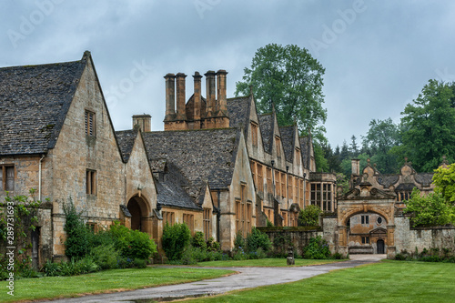 STANWAY, ENGLAND - MAY, 26 2018: Stanway Manor House built in Jacobean period architecture 1630 in guiting yellow stone, in the Cotswold village of Stanway, Gloucestershire, Cotswolds, UK    photo