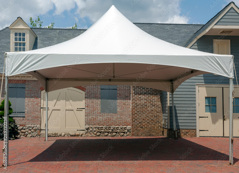 White event tent canopy erected on brick patio. - obrazy, fototapety, plakaty 