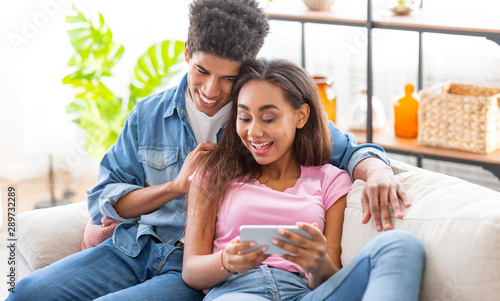 African american teens watching videos online on smartphone