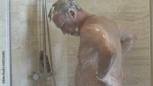 man washes in the shower photo