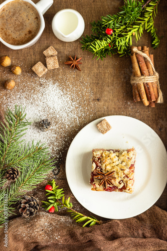 Apple pie bars with red berry jam, spices and crumble. Crumble cake. Christmas or New Year background.
