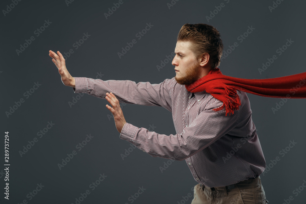 Strong wind blowing on man in red scarf - obrazy, fototapety, plakaty 