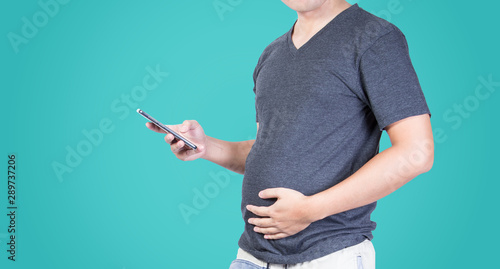 fat man belly fat overweight hand holding mobile phone