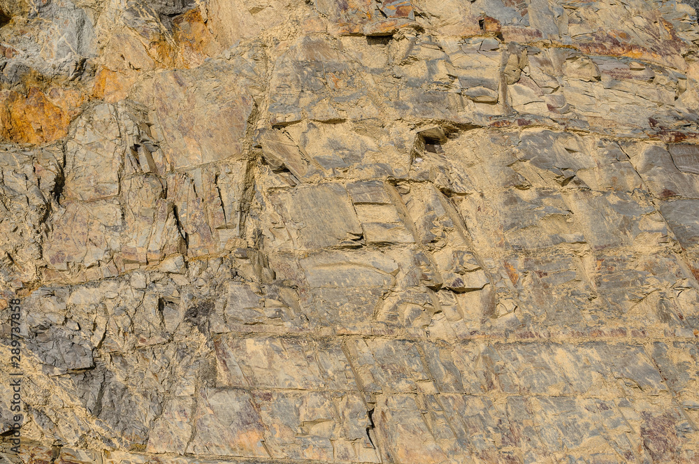 Texture of dark yellow granite stone or background for design..The surface of the rock with a texture pattern for the tiles. Texture of dark yellow granite stone or background for design..The surface of the rock with a texture pattern for the tiles.