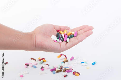 man holding pills on hand medicine health care concept on white background