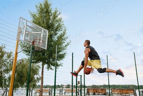 Basketball player makes a throw in jump, outdoor