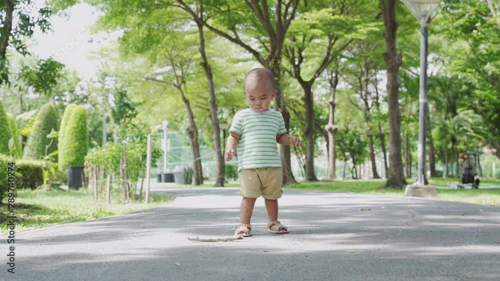 Baby boy feeling happy to walking in the park. Happy family in the park concept. Baby boy feeling happy to walking in the park. Happy family in the park concept.