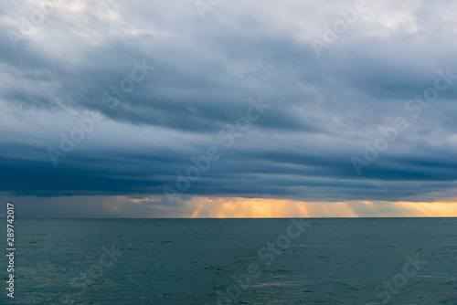 Vivid sunset over the Black Sea with rainy clouds © vahanabrahamyan