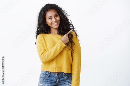 Konstfotografi Friendly cheerful female student study abroad showing friend around, pointing up