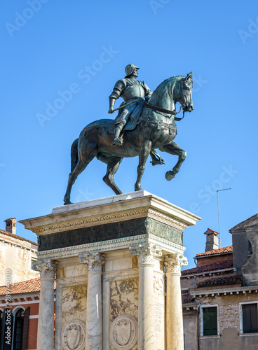 Statue of Bartolomeo Colleoni of 15th century, Venice, Italy. Old monument, bronze sculpture of the Renaissance. Equestrian statue of famous commander of Venice city in summer. Medieval art of Venice. photo
