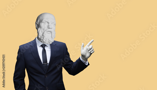 Modern art collage. Concepе зortrait of a  Modern art collage. Concept portrait of a  businessman pointing finger .Gypsum head of of Socrates. Man in suit. photo