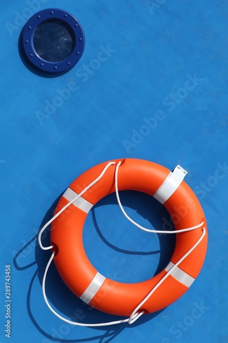 Close-up of a bright life buoy on a blue background