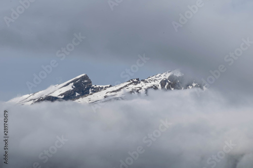 Snow Peaks over the clouds, Switzerland's Alps photo