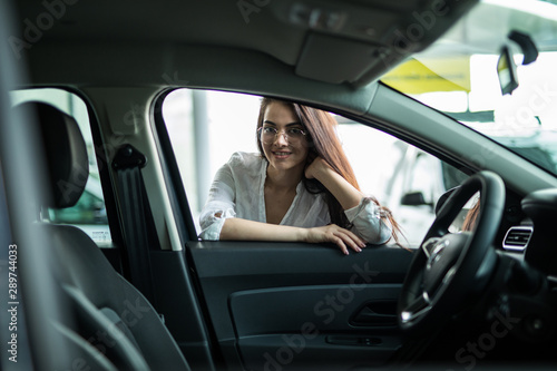 Car dealer woman. Auto dealership and rental concept background.