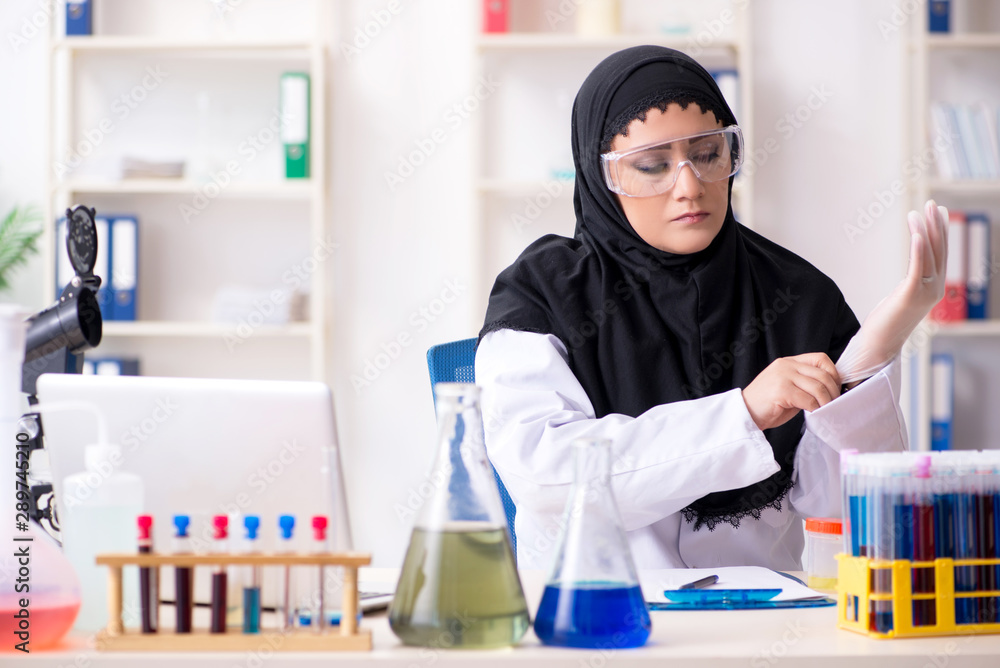 Female chemist in hijab working in the lab Female chemist in hijab working in the lab