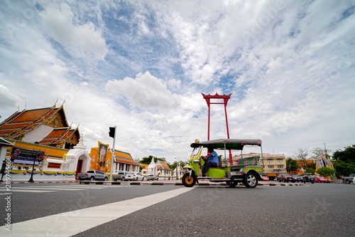 Canvas Print Tuk tuk and Red giant swing landmark in Bangkok city, Thailand,Sep 10,2019