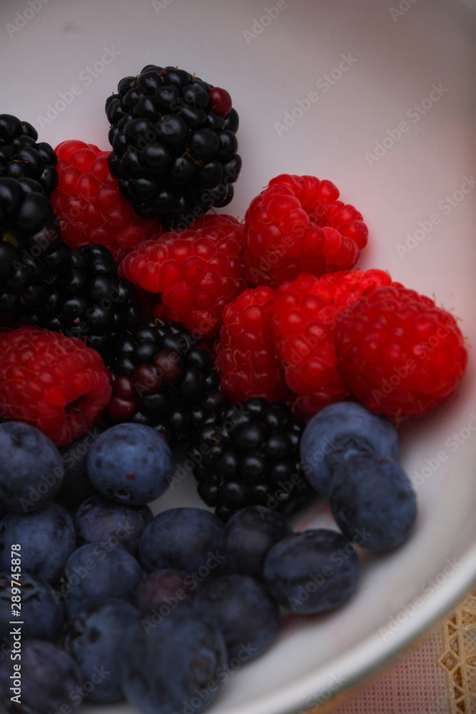 Background of fresh fruits and berries. Ripe blackberries, blueberries, plums, raspberries. Mix berries and fruits. Top view. Background berries and fruits. Black-blue and red food. Background of fresh fruits and berries. Ripe blackberries, blueberries, plums, raspberries. Mix berries and fruits. Top view. Background berries and fruits. Black-blue and red food.