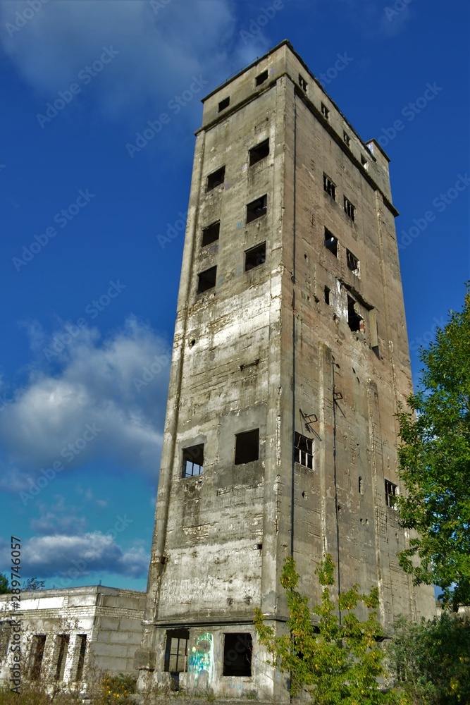 Russia, Nizhny Novgorod region,29.08.2019 year .Old abandoned Elevator (granary).Gray tower.rey old wall with empty window