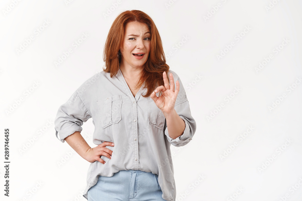 You look stunning darling. Impressed satisfied redhead cheeky middle-aged woman check out perfect choice show not bad okay ok excellent gesture winking approval like emotion, white background You look stunning darling. Impressed satisfied redhead cheeky middle-aged woman check out perfect choice show not bad okay ok excellent gesture winking approval like emotion, white background