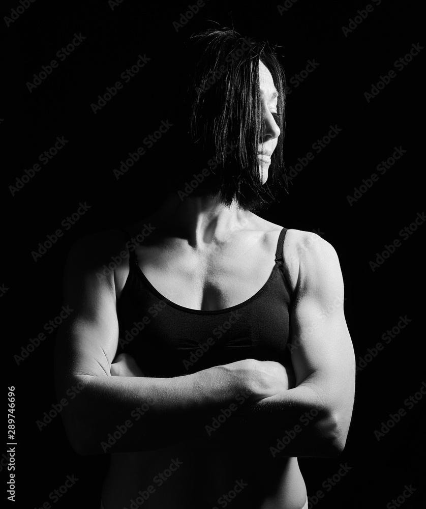 Obraz premium portrait of a beautiful athletic girl with black hair, her arms crossed