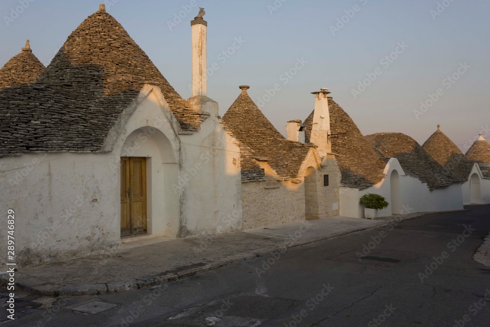 ALBEROBELLO, ITALY - AUGUST 28 2017: sunset view of a street in Alberobello, Italy