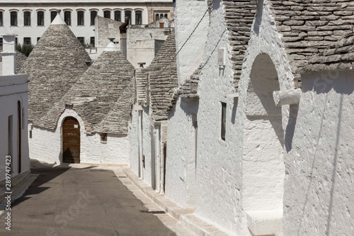 ALBEROBELLO, ITALY - AUGUST 28 2017: Day view of Alberobello road in Italy photo